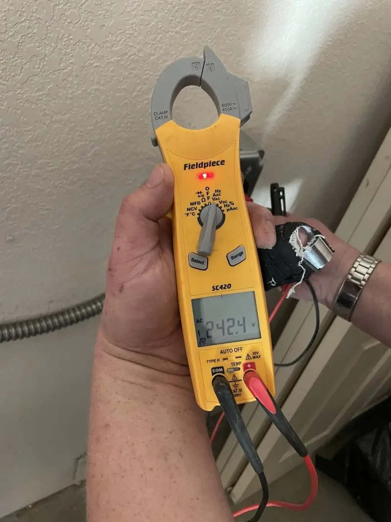 Voltage testing with clamp meter during Generator Installation in Whiskey Creek